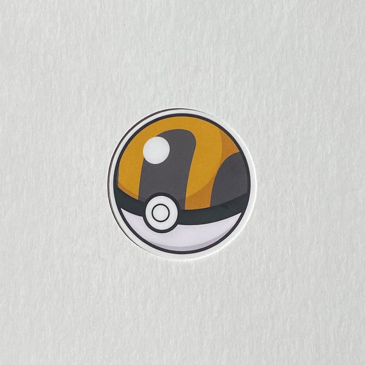 Ultra ball sticker. Pokemon merch. Poke ball sticker. Nintendo merch. White background.